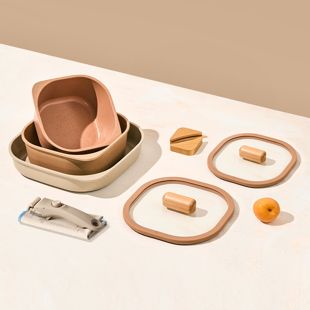 Set of terracotta and beige containers with lids, shown with wooden grips and a detachable handle.