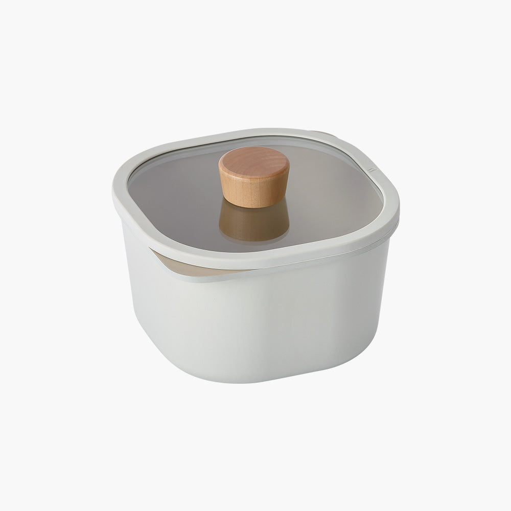 A square, off-white storage container with a glass lid and a wooden handle on top.