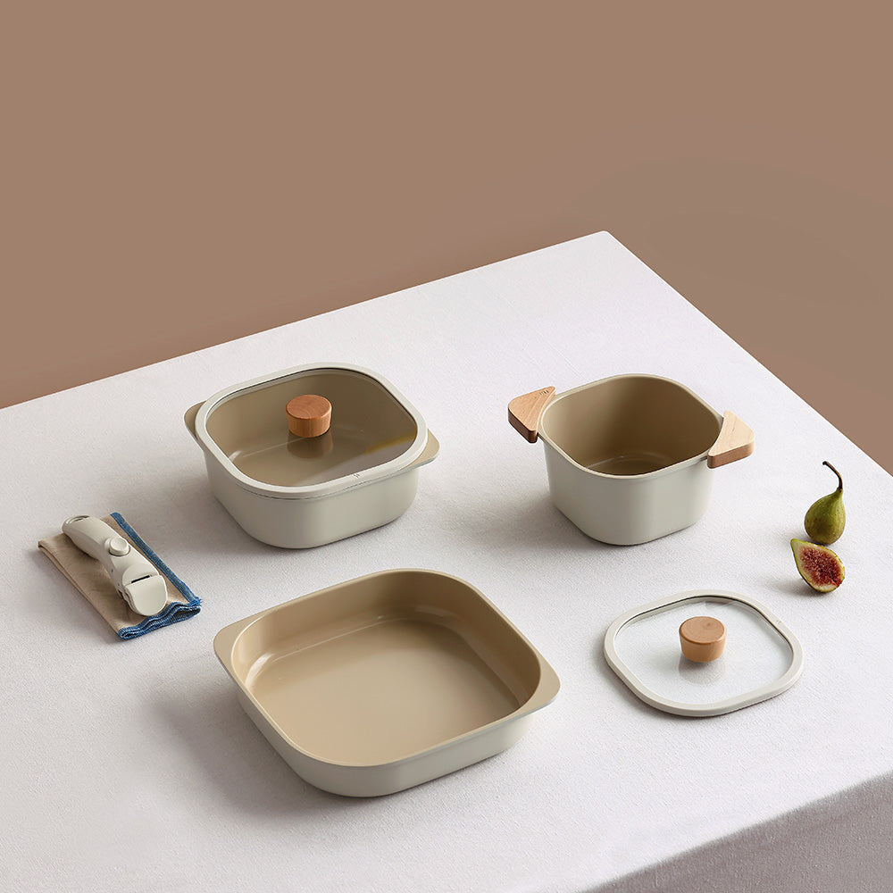 A set of square, beige storage containers with matching lids and a detachable handle, arranged neatly on a table.