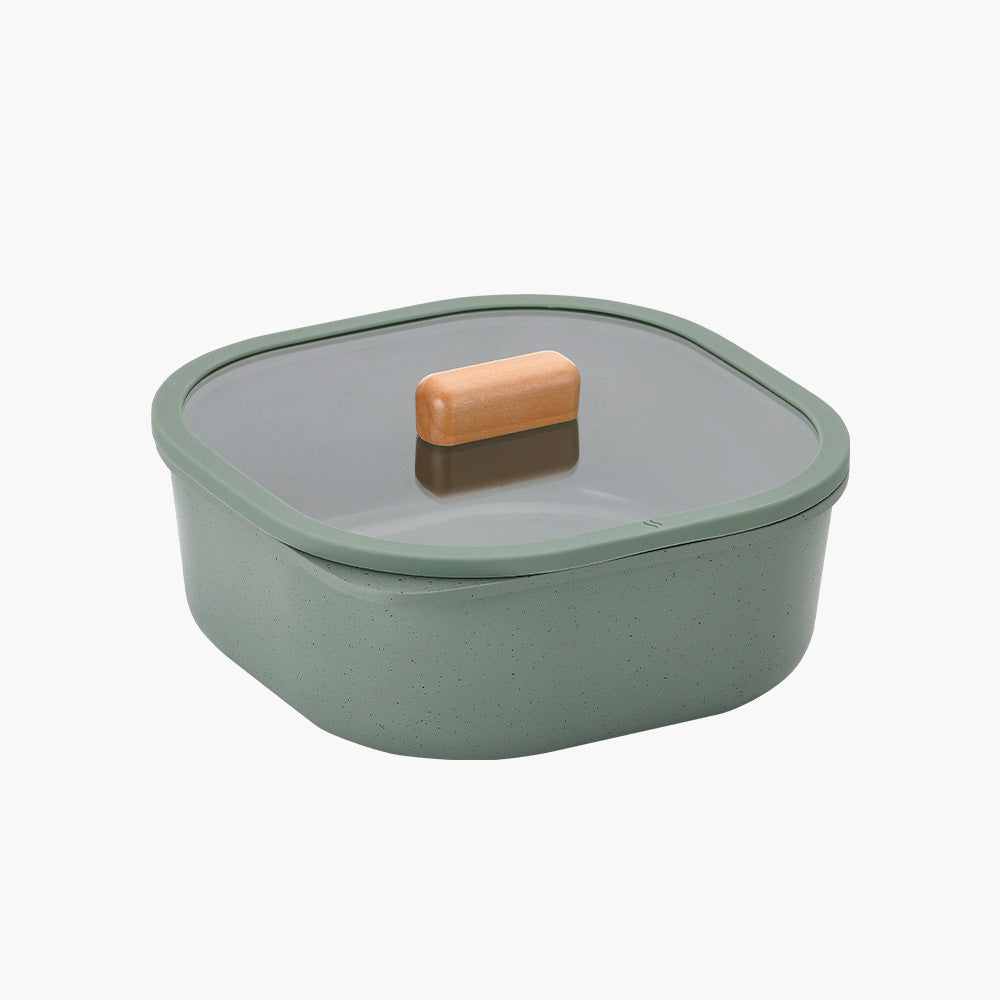 Light green square food storage container with a glass lid featuring a wooden handle.